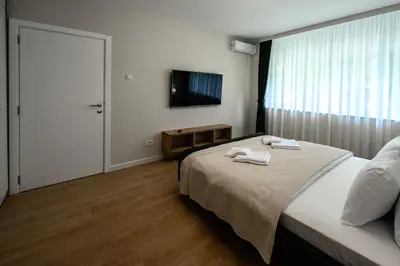 a bedroom with a bed with two towels on it at Lux Apartment 88 in Kotor