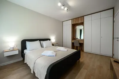 a bedroom with a bed with two towels on it at Lux Apartment 88 in Kotor