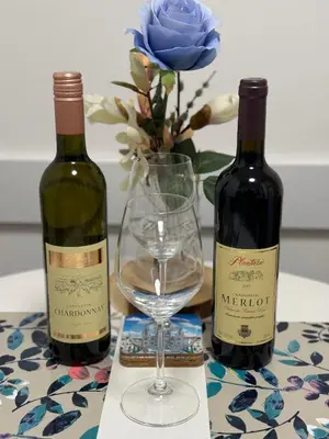 two bottles of wine and a glass on a table at Eleven in Podgorica