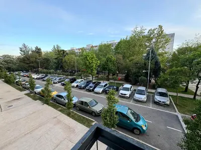 a parking lot with a bunch of cars parked at Eleven in Podgorica