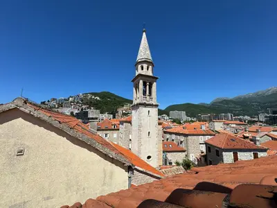 a view of a city with a clock tower at Santa Maria - Old Town Apartment in Budva