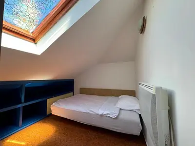 a small bedroom with a bed and a window at Santa Maria - Old Town Apartment in Budva