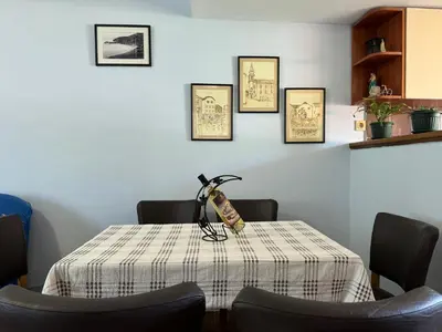 a dining room table with a table cloth on it at Santa Maria - Old Town Apartment in Budva
