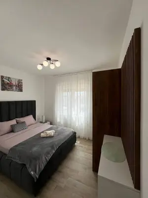a bedroom with a large bed and a window at Frekuenca Apartments in Ulcinj
