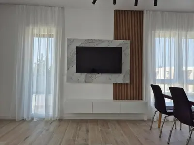 a living room with a television on a wall at Frekuenca Apartments in Ulcinj