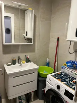 a bathroom with a sink and a washing machine at Apartment Veljko Becici in Becici