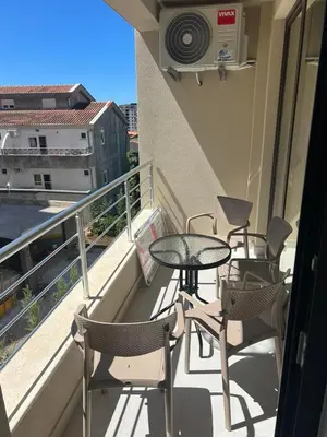 a balcony with a table and chairs on a building at Apartment Veljko Becici in Becici