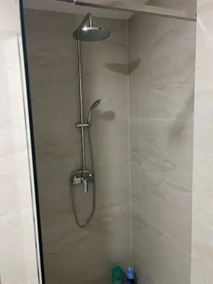 a shower with a shower head in a bathroom at Apartment Veljko Becici in Becici