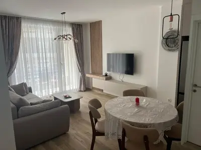 a living room with a table and a couch at Apartment Veljko Becici in Becici