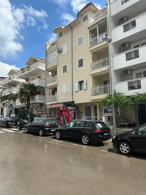 a group of cars parked in front of a building at Aprtment Mili in Budva