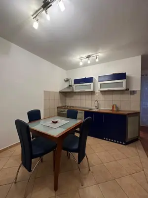 a kitchen with a table and chairs in a room at Aprtment Mili in Budva