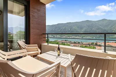 a balcony with a table and chairs and a view at ALISA Sea View Apartment in Kotor