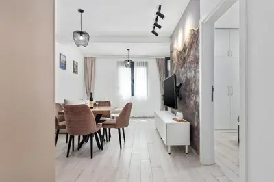 a living room with a table and a dining room at ALISA Sea View Apartment in Kotor