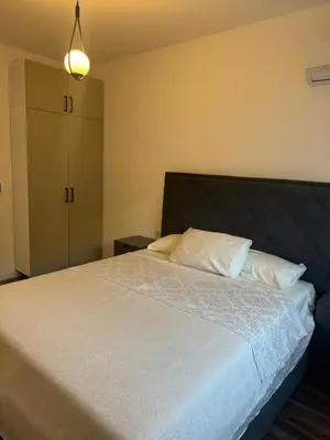 a bedroom with a large bed with white sheets at Luxury Ocean View in Ulcinj