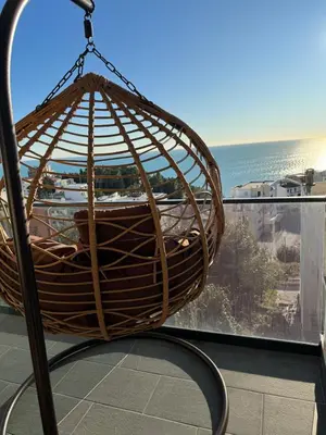 a basket swing on a balcony with a view of the ocean at Luxury Ocean View in Ulcinj