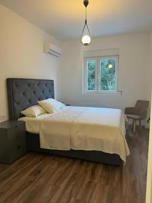 a bedroom with a large bed and a window at Luxury Ocean View in Ulcinj
