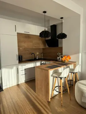 a kitchen with white cabinets and a wooden counter top at Luxury Ocean View in Ulcinj