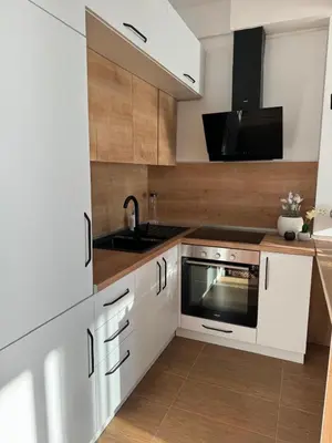 a kitchen with white cabinets and a sink at Luxury Ocean View in Ulcinj