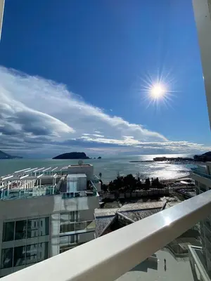 a view of the ocean from a balcony of a building at Apartment in Tre Canne in Budva