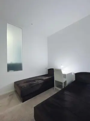 a bedroom with a bed and a table and a chair at Apartment in Tre Canne in Budva