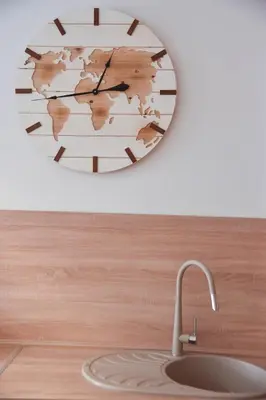 a clock hanging on a wall next to a sink at Dolami residence in Becici