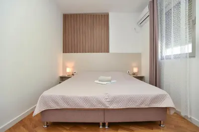 a bedroom with a bed and a shower at Dolami residence in Becici