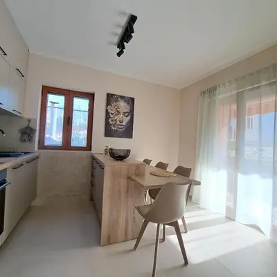 a kitchen with a table and chairs in a room at Bubi in Kotor