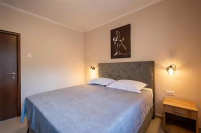 a bedroom with a large bed with two white pillows at Bubi in Kotor
