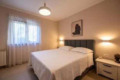 a bedroom with a large bed and a window at Bubi in Kotor