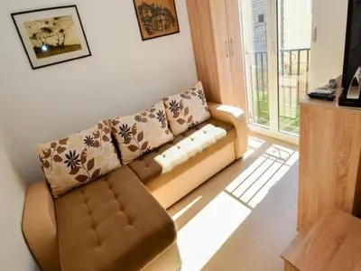 a living room with a couch and a window at Apartment Anlave in Sveti Stefan