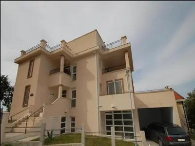 a house with a car parked in front of it at Apartment Anlave in Sveti Stefan