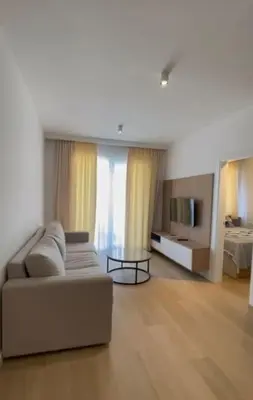 a living room with a couch and a tv at DH Horizon Residences in Budva