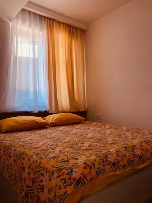 a bedroom with a large bed with a window at DH Horizon Residences in Budva