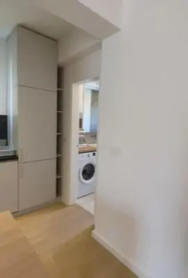 a laundry room with a washer and a washing machine at DH Horizon Residences in Budva