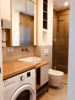 a bathroom with a sink and a washing machine at DH Horizon Residences in Budva