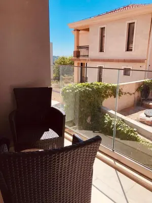 a balcony with a chair and a view of a building at DH Horizon Residences in Budva