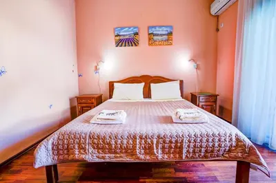 a bedroom with a bed with two towels on it at Apartment Donji Stoj, Ulcinj, rosso in Donji Štoj