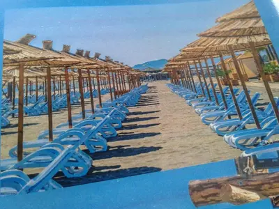 a painting of a beach with chairs and umbrellas at Apartment Donji Stoj, Ulcinj, rosso in Donji Štoj