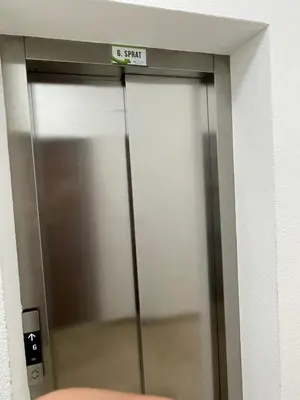 an elevator door with a sign on top of it at Apartments Moreno in Budva