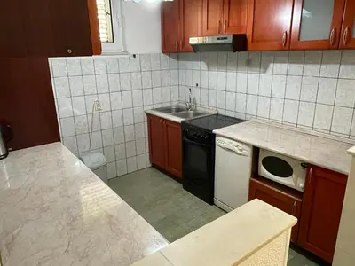 a small kitchen with a sink and a dishwasher at Apartments Moreno in Budva