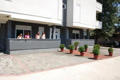 a group of women sitting on a balcony of a building at Apartmen Donji Stoj, yellow in Donji Štoj