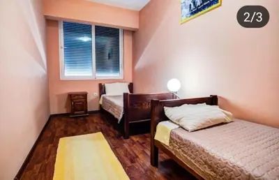 a bedroom with two beds and a window at Apartmen Donji Stoj, yellow in Donji Štoj