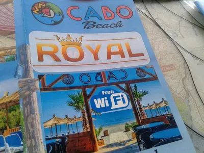 a sign for aroolani restaurant on a pole at Apartmen Donji Stoj, yellow in Donji Štoj