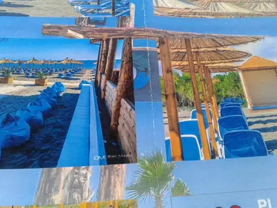 a painting of a beach with chairs and umbrellas at Apartmen Donji Stoj, yellow in Donji Štoj