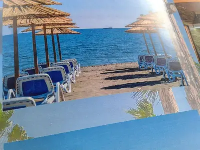 a painting of a beach with chairs and umbrellas at Apartmen Donji Stoj, yellow in Donji Štoj
