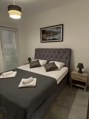 a bedroom with a bed with two towels on it at Masha Apartment in Budva