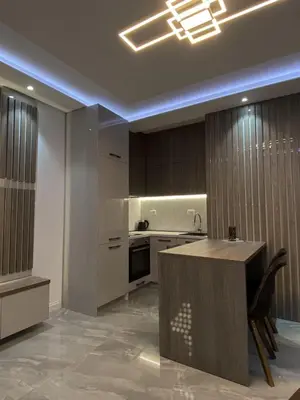 a kitchen with a island in the middle of a room at Masha Apartment in Budva