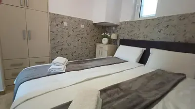 a bedroom with a bed with a scale on it at Apartment deluxe Ina FREE PARKING in Budva