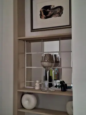 a shelf with a wine glass in a room at Apartment deluxe Ina FREE PARKING in Budva