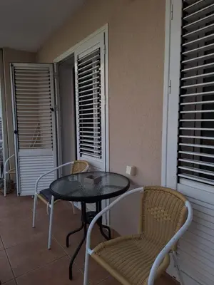 a patio with a table and chairs on a balcony at Apartment deluxe Ina FREE PARKING in Budva